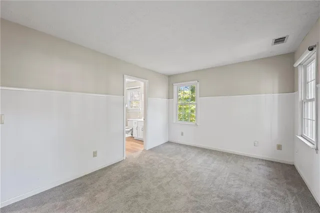 a bathroom with a granite countertop sink a mirror and shower