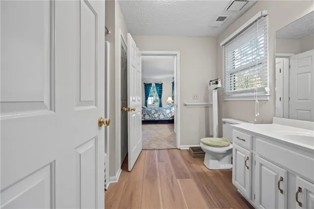 a bathroom with a granite countertop double vanity sink and a mirror