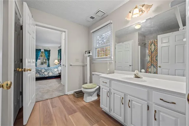 a bathroom with a toilet and a shower