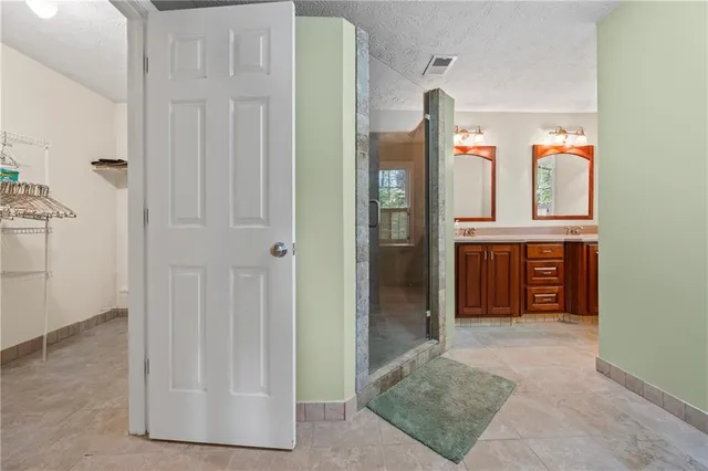 a utility room with a shower and a ceiling fan