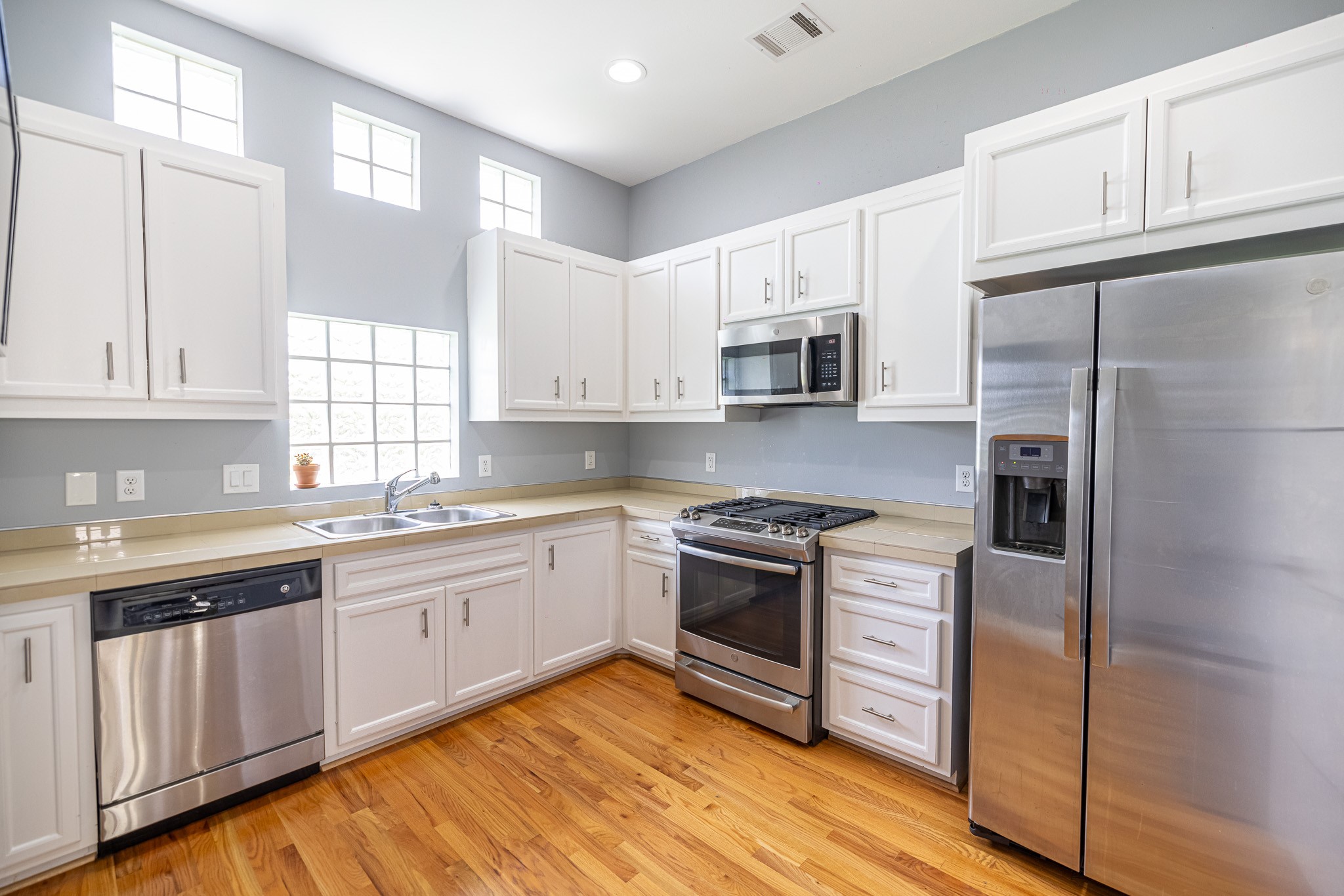 8705 Bryam Street, Unit 303 Houston, TX 77061 - Photo 12 of 14 a kitchen with stainless steel appliances granite countertop a stove a sink and a refrigerator