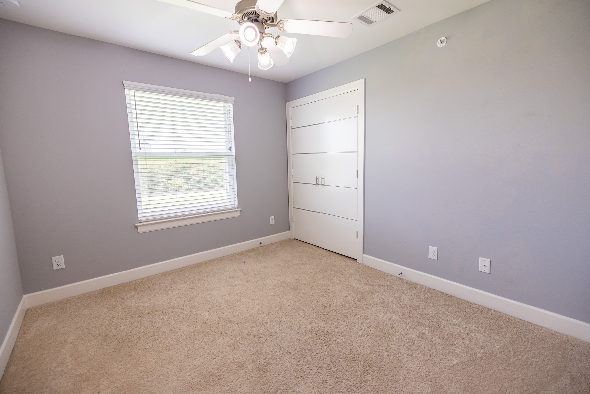 8705 Bryam Street, Unit 303 Houston, TX 77061 - Photo 14 of 14 an empty room with chandelier fan and windows