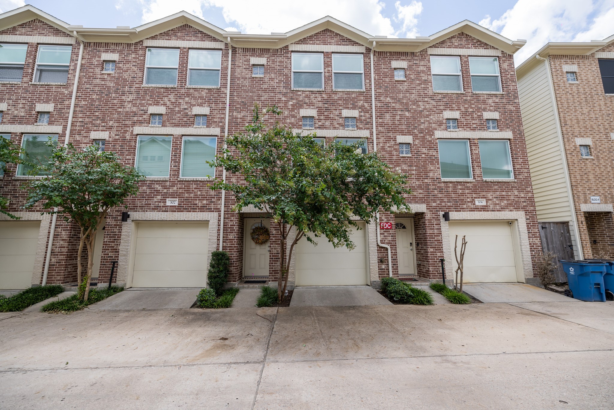 8705 Bryam Street, Unit 303 Houston, TX 77061 - Photo 2 of 14 a front view of a house with a yard and garage