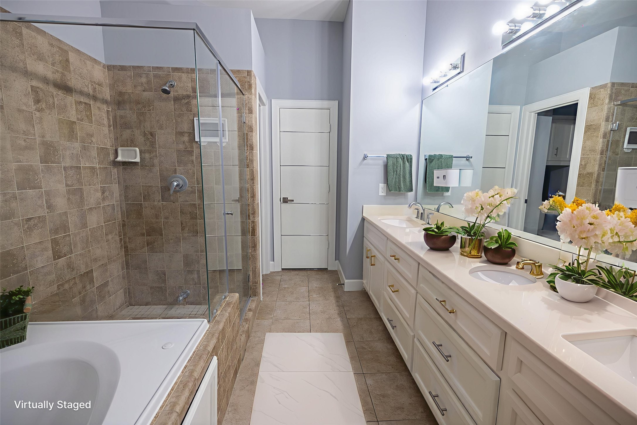 8705 Bryam Street, Unit 303 Houston, TX 77061 - Photo 3 of 14 a spacious bathroom with a double vanity sink a large mirror a bathtub and shower