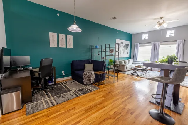 a living room with furniture a wooden floor and a sink