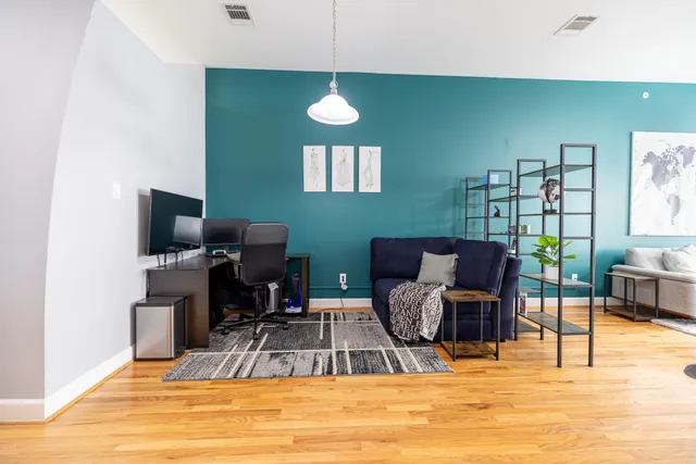 a view of a livingroom with furniture and a window