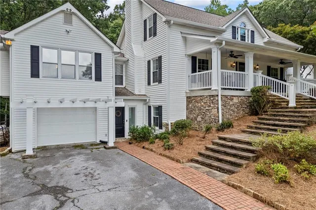 a living room with furniture a ceiling fan and a fireplace