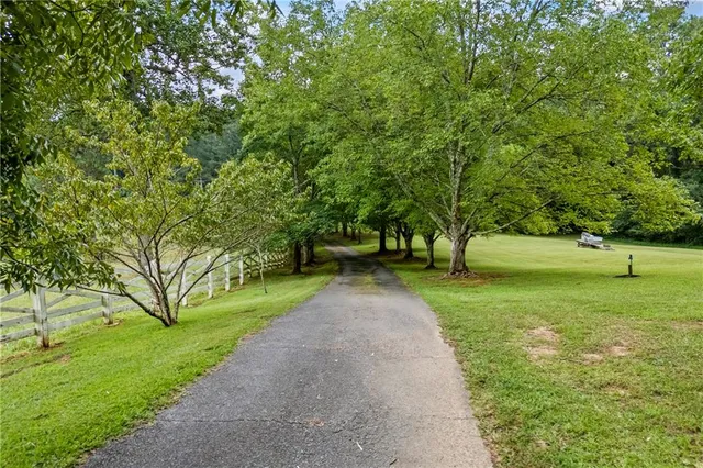 a dining room with furniture a chandelier and wooden floor
