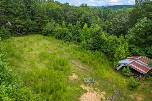 a kitchen with stainless steel appliances granite countertop a sink window and cabinets