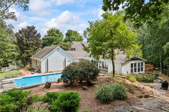 a view of a house with backyard and sitting area