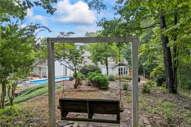 an aerial view of a house with a yard and outdoor seating