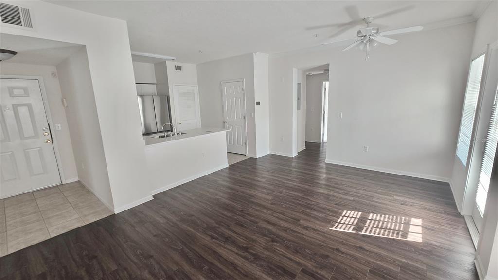 791 Celebration Avenue, Unit 791 Celebration, FL 34747 - Photo 11 of 27 an empty room with wooden floor and ceiling fan
