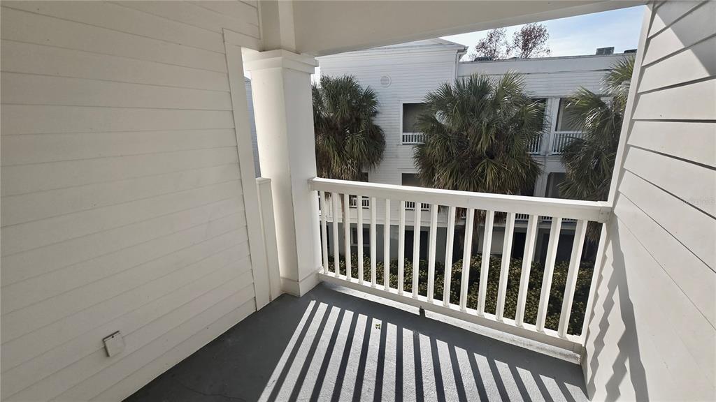 791 Celebration Avenue, Unit 791 Celebration, FL 34747 - Photo 12 of 27 a view of a balcony with wooden floor