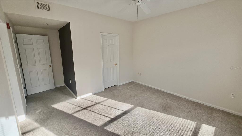 791 Celebration Avenue, Unit 791 Celebration, FL 34747 - Photo 14 of 27 an empty room with a bench and a mirror