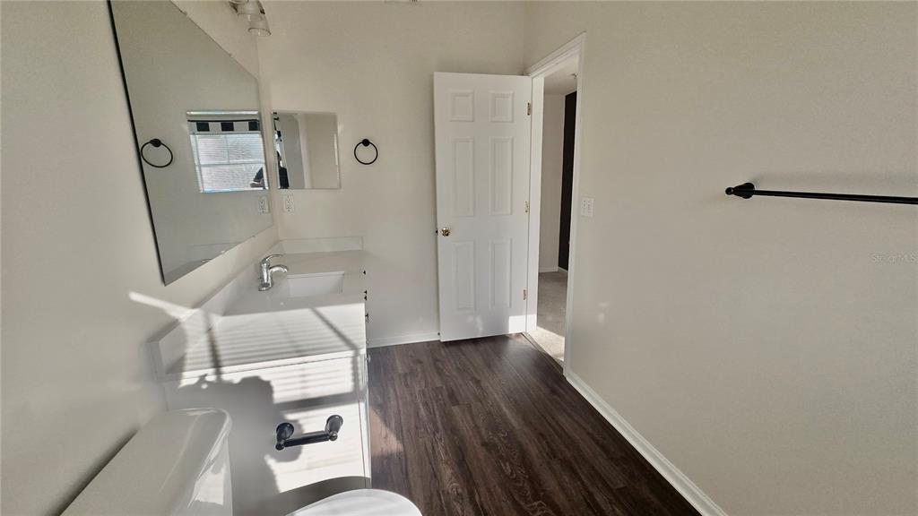 791 Celebration Avenue, Unit 791 Celebration, FL 34747 - Photo 26 of 27 a bathroom with a sink and a mirror