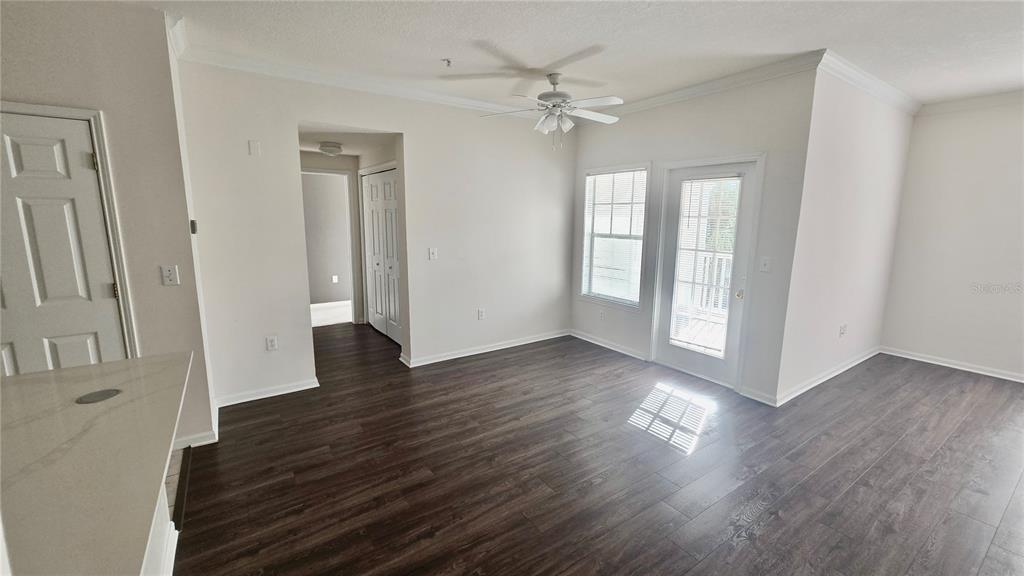 791 Celebration Avenue, Unit 791 Celebration, FL 34747 - Photo 5 of 27 an empty room with wooden floor and windows
