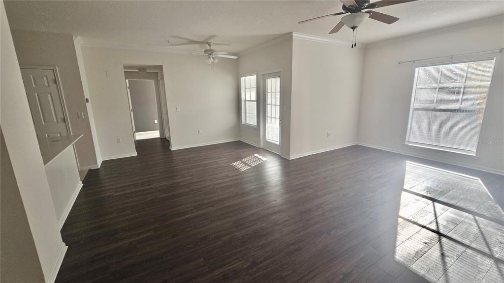 791 Celebration Avenue, Unit 791 Celebration, FL 34747 - Photo 6 of 27 an empty room with wooden floor and windows
