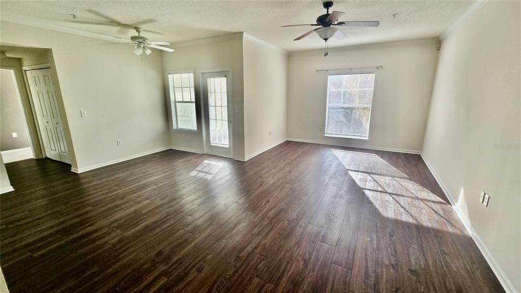 791 Celebration Avenue, Unit 791 Celebration, FL 34747 - Photo 8 of 27 wooden floor in an empty room with a window
