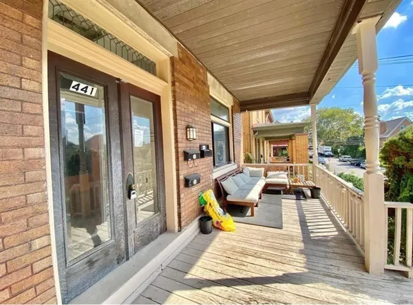 a view of a patio with table and chairs with wooden floor and fence