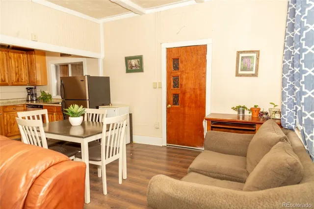 a view of a dining room with furniture window and wooden floor
