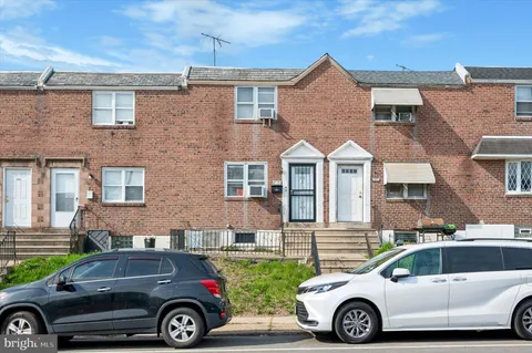 a front view of a house with parking space