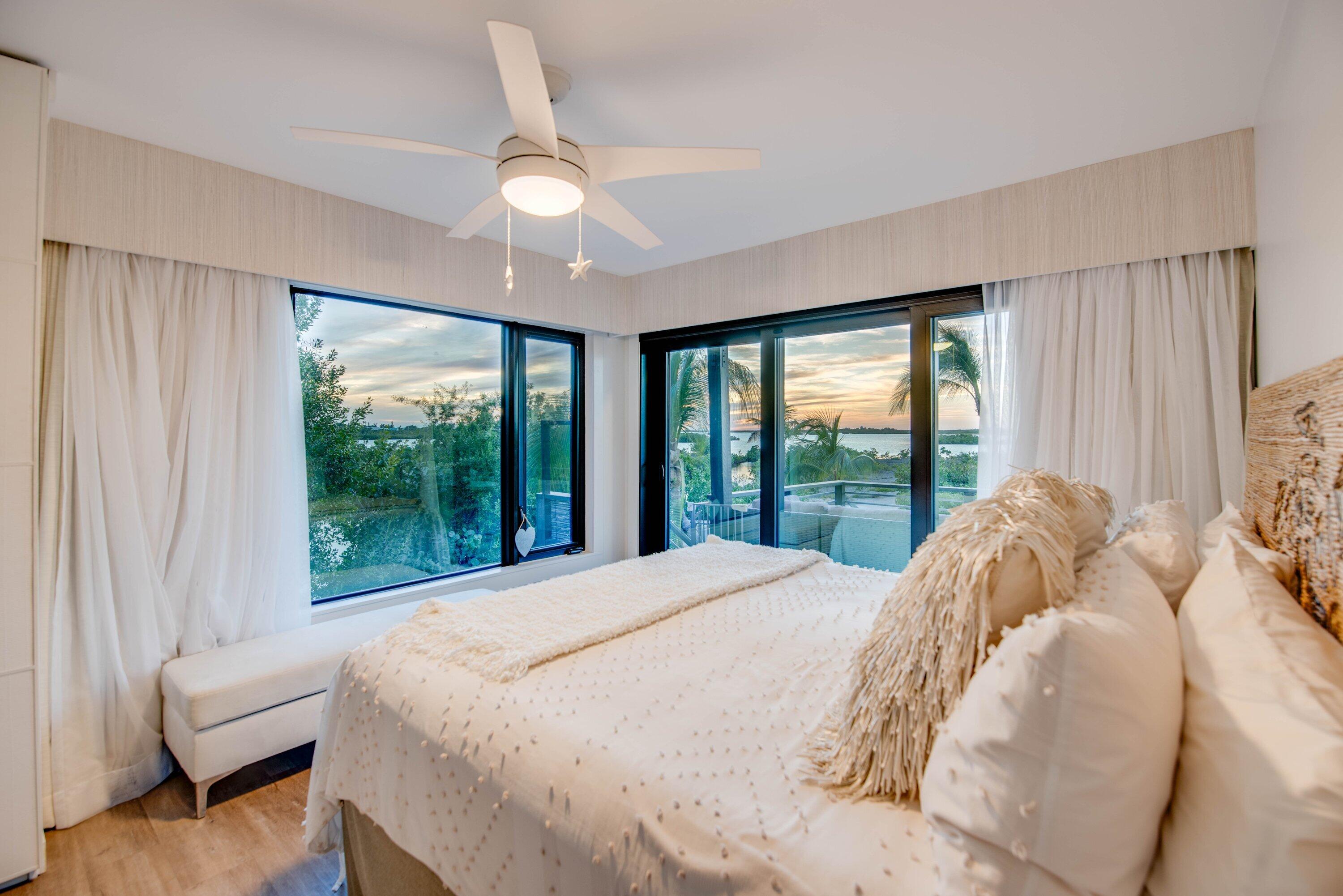 1422 Boca Chica Road Key West, FL 33040 - Photo 25 of 54 a bed sitting in a bedroom next to a window