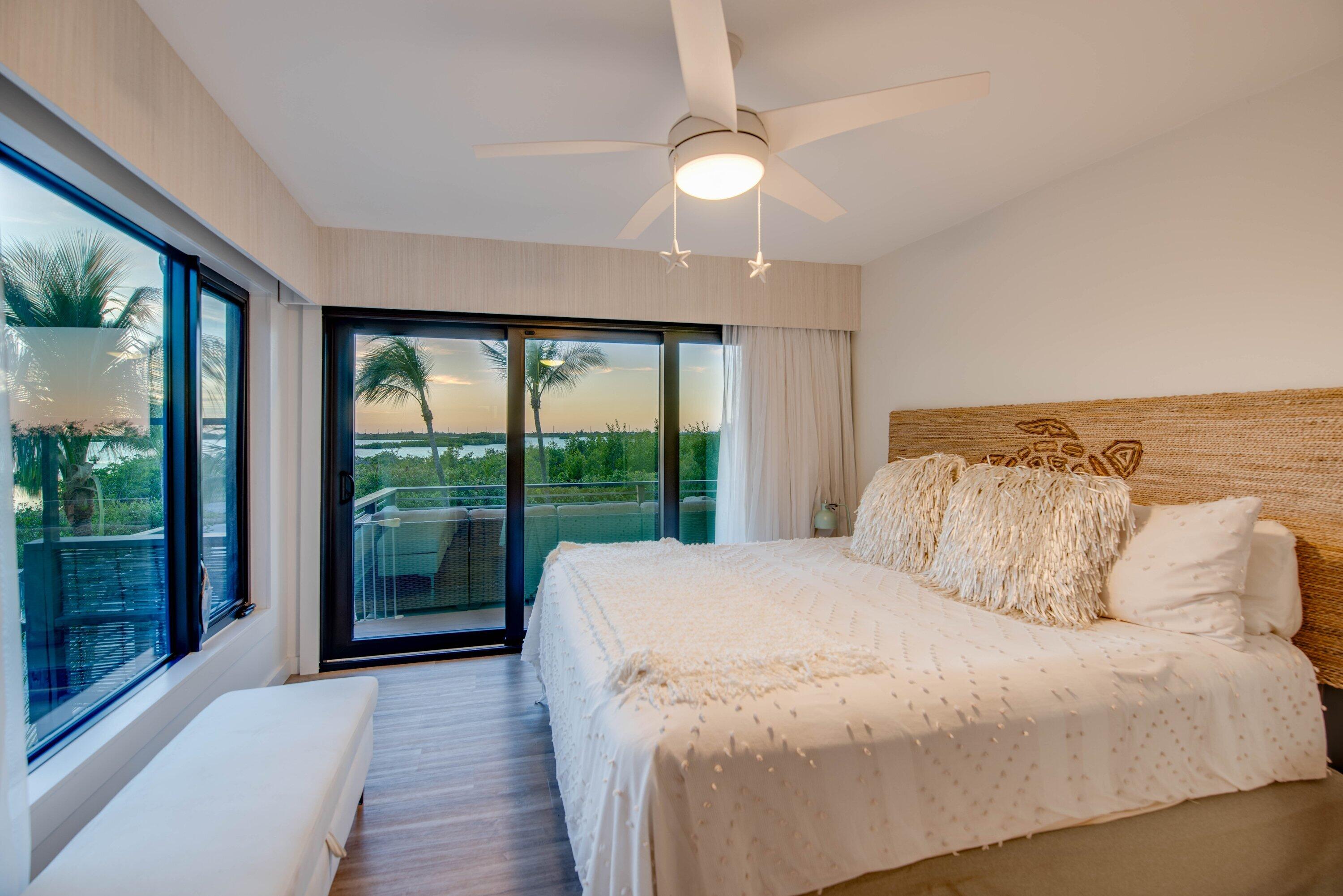 1422 Boca Chica Road Key West, FL 33040 - Photo 26 of 54 a bedroom with a large bed and a large window