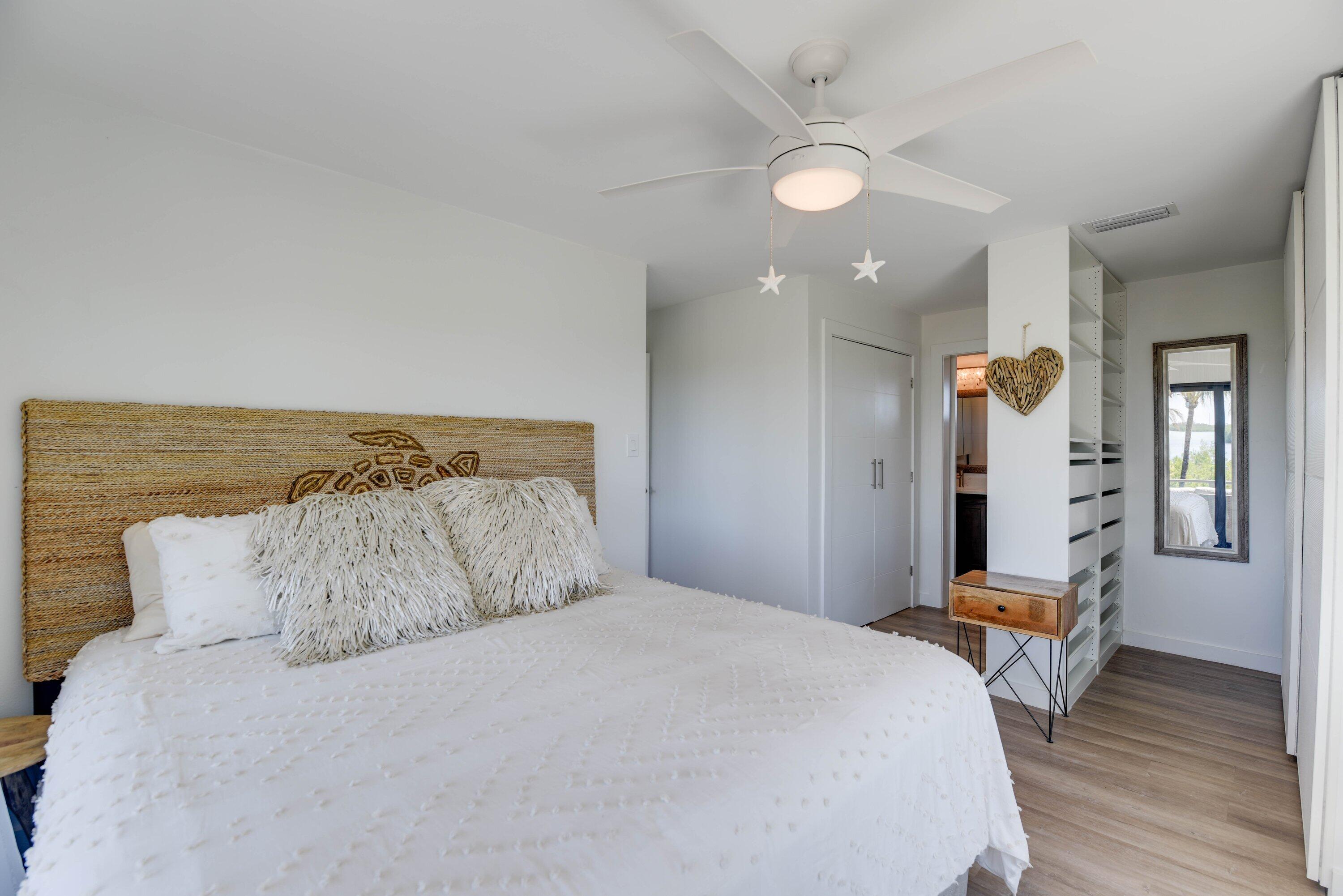 1422 Boca Chica Road Key West, FL 33040 - Photo 29 of 54 a bedroom with a bed and wooden floor