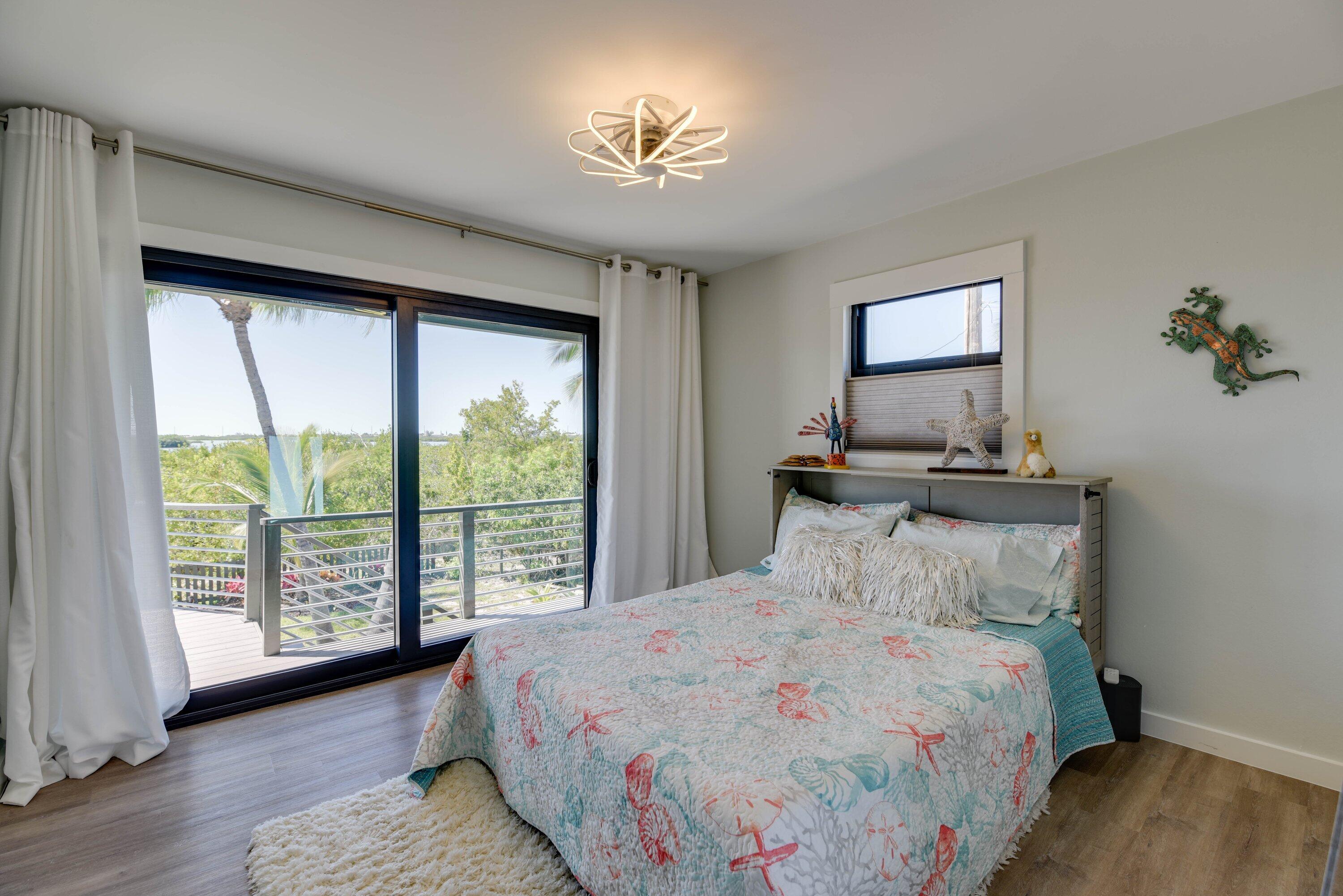 1422 Boca Chica Road Key West, FL 33040 - Photo 32 of 54 a bedroom with a large bed and a window