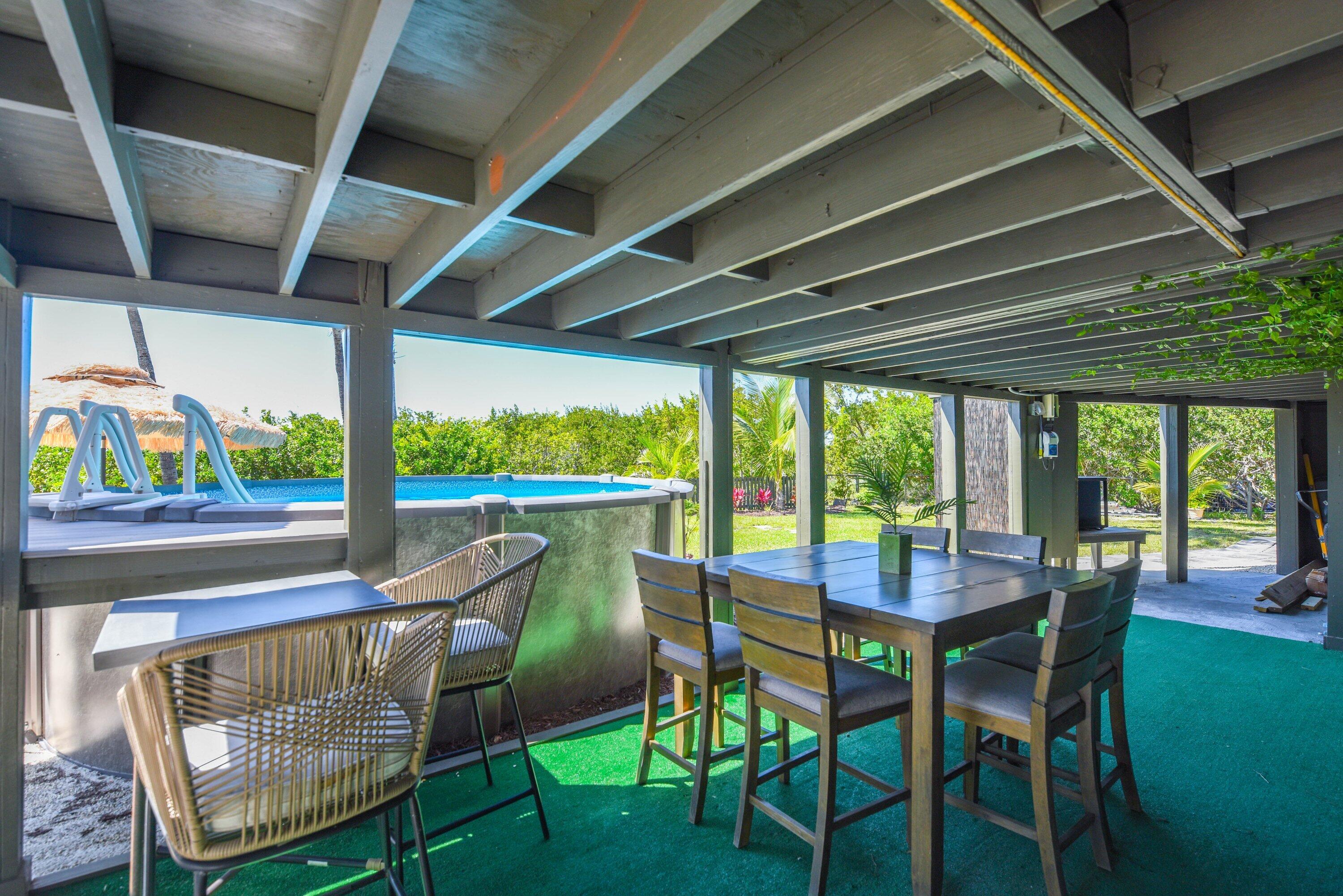 1422 Boca Chica Road Key West, FL 33040 - Photo 53 of 54 a dining room with furniture and a floor to ceiling window