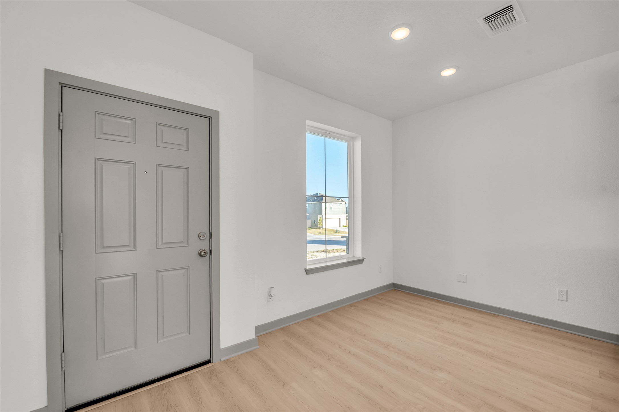 270 Boatright Boulevard Jarrell, TX 76537 - Photo 17 of 30 an empty room with wooden floor and windows