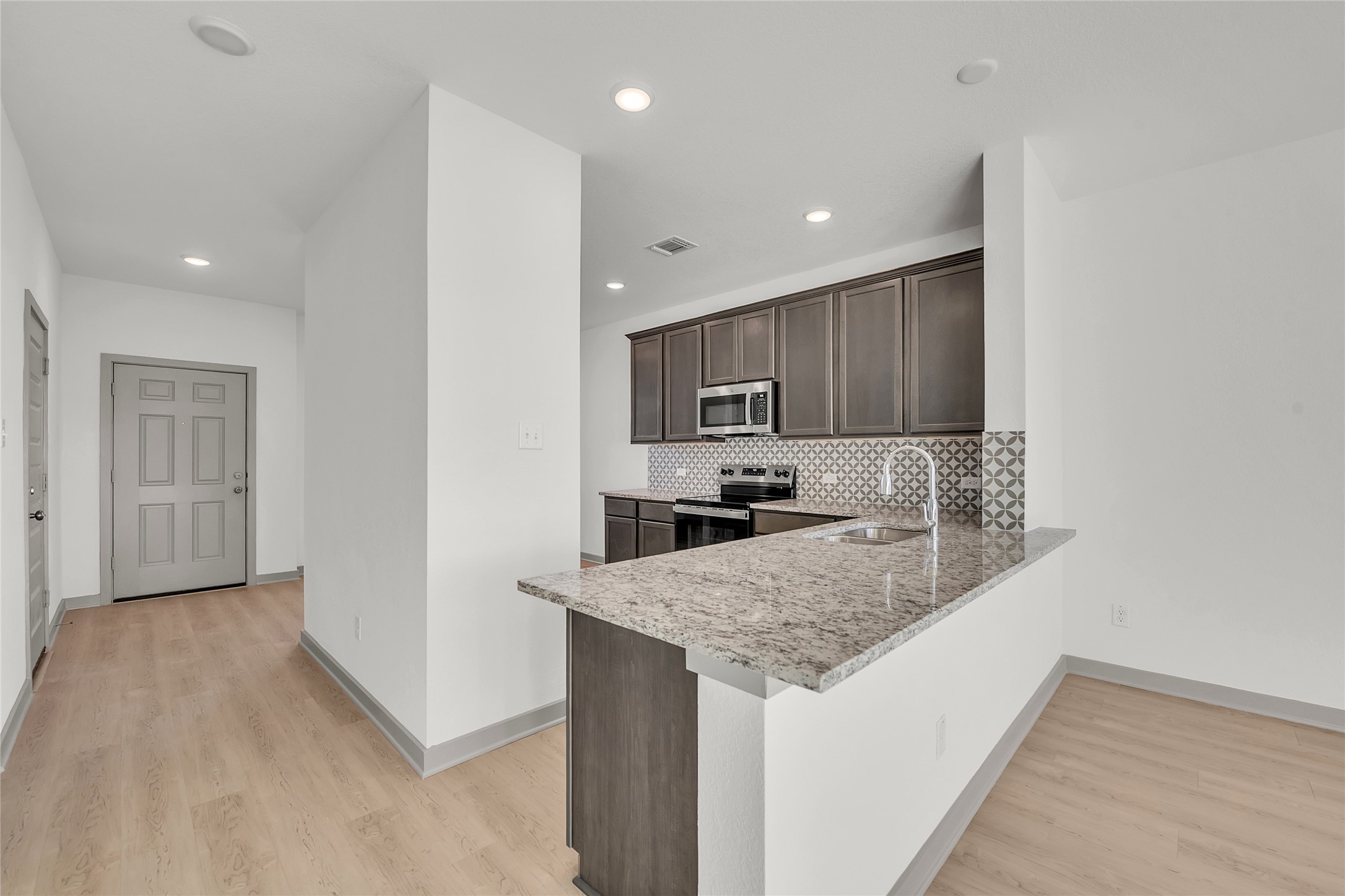 270 Boatright Boulevard Jarrell, TX 76537 - Photo 28 of 30 a kitchen with a sink a counter top space cabinets and stainless steel appliances