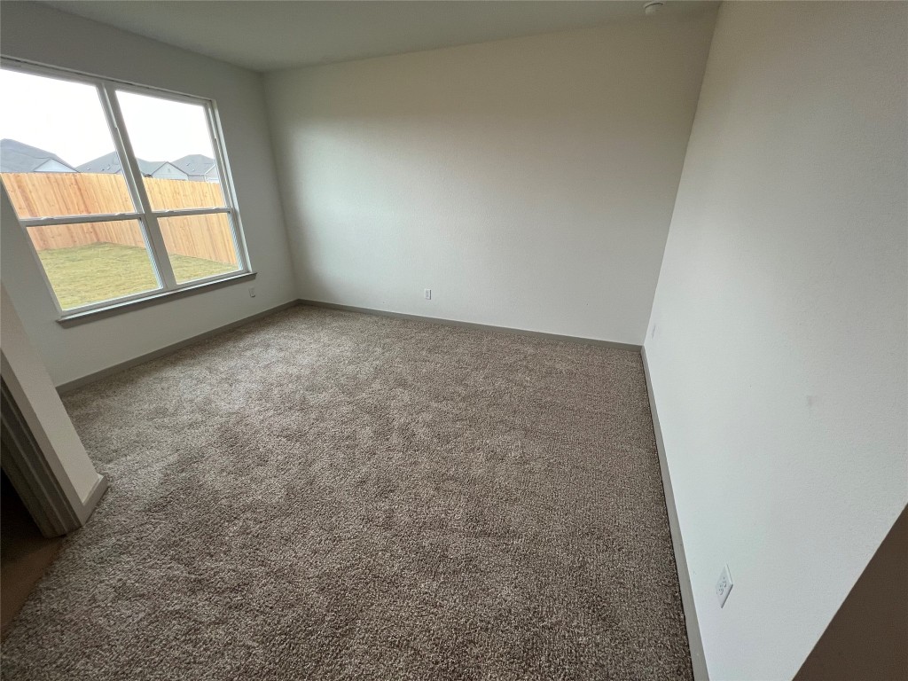 270 Boatright Boulevard Jarrell, TX 76537 - Photo 5 of 7 Carpeted empty room featuring baseboards