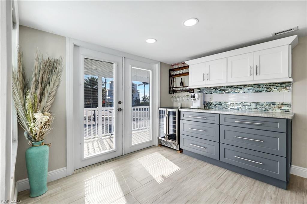 100 Tarpon Road Fort Myers Beach, FL 33931 - Photo 11 of 49 a kitchen with white cabinets and window