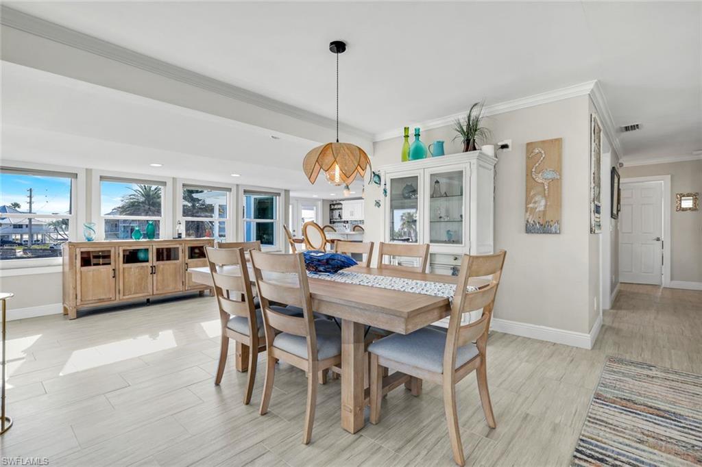 100 Tarpon Road Fort Myers Beach, FL 33931 - Photo 13 of 49 a dining room with furniture a chandelier and wooden floor