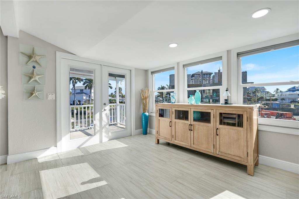 100 Tarpon Road Fort Myers Beach, FL 33931 - Photo 14 of 49 a large white room with stainless steel appliances wooden floor and window