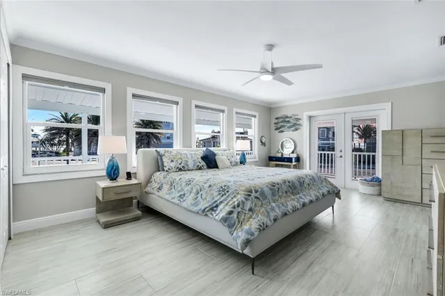 a living room with a bed furniture and windows