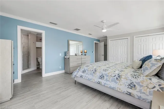 a bedroom with a large bed and a chandelier