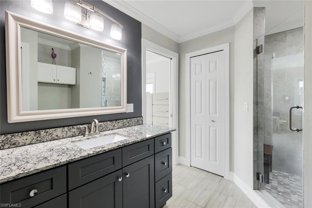 100 Tarpon Road Fort Myers Beach, FL 33931 - Photo 19 of 49 a bathroom with a granite countertop sink and a mirror