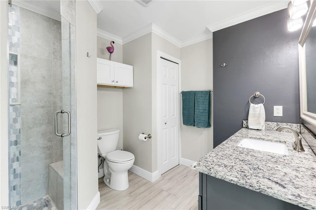 100 Tarpon Road Fort Myers Beach, FL 33931 - Photo 20 of 49 a bathroom with a granite countertop sink a toilet and shower