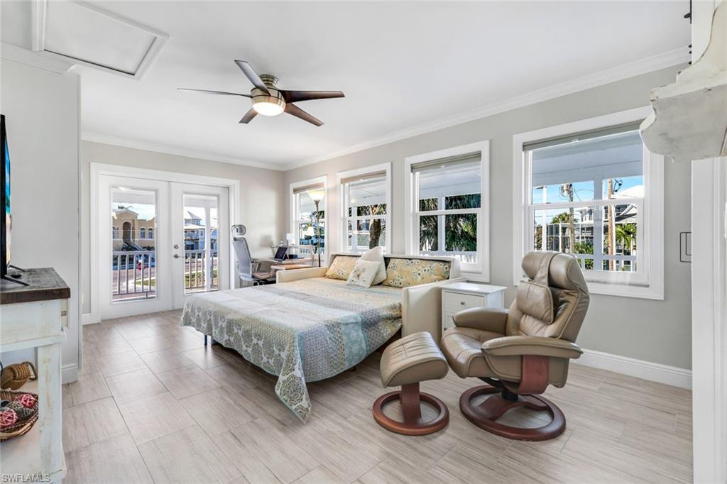 100 Tarpon Road Fort Myers Beach, FL 33931 - Photo 21 of 49 a living room with furniture a rug potted plant and windows