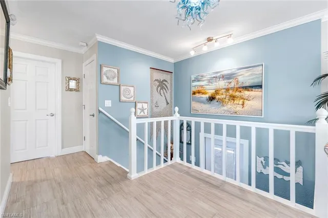a view of hallway with wooden floor