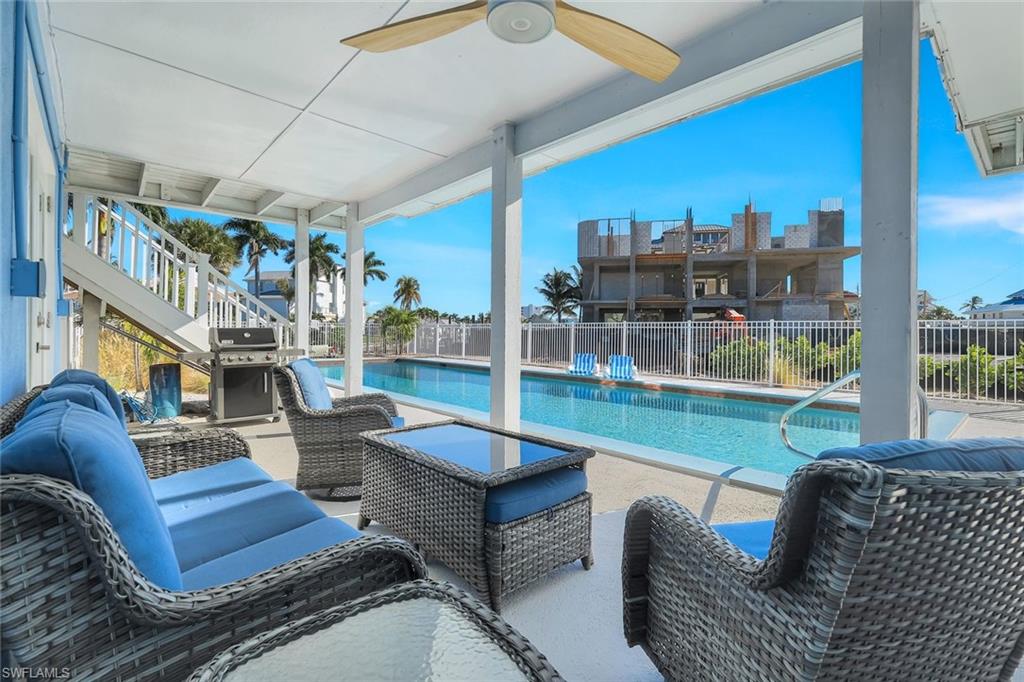 100 Tarpon Road Fort Myers Beach, FL 33931 - Photo 31 of 49 a living room with furniture a fireplace and a large window