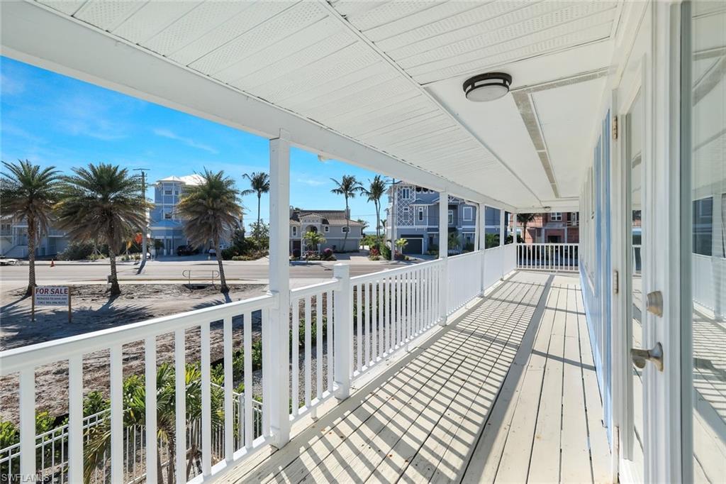 100 Tarpon Road Fort Myers Beach, FL 33931 - Photo 38 of 49 a view of balcony with a floor to ceiling window and wooden floor