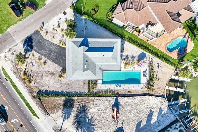 a view of a park with plants and palm trees