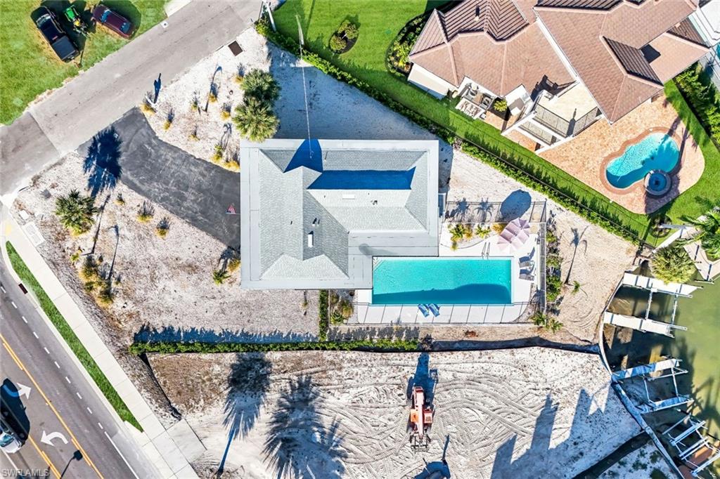 100 Tarpon Road Fort Myers Beach, FL 33931 - Photo 41 of 49 a view of a house with a yard and potted plants