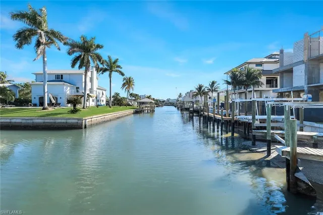 a view of a house with pool and chairs