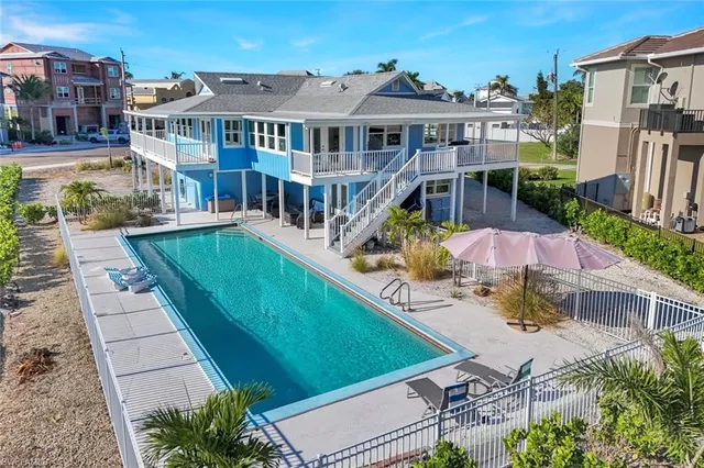 a aerial view of a house with a swimming pool patio and outdoor seating