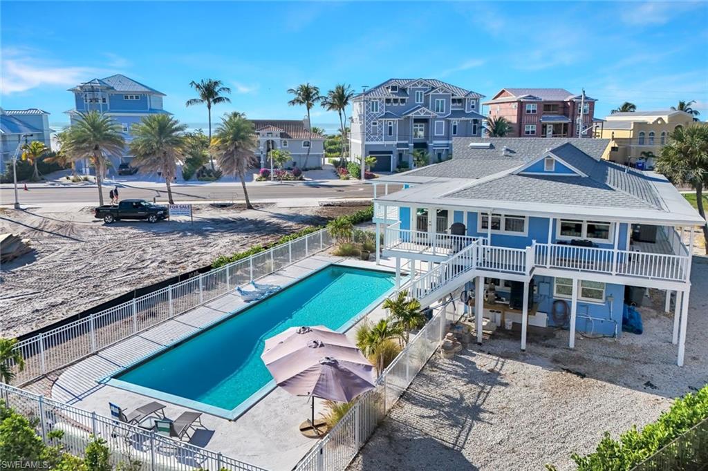 100 Tarpon Road Fort Myers Beach, FL 33931 - Photo 46 of 49 a aerial view of a house with a swimming pool patio and outdoor seating