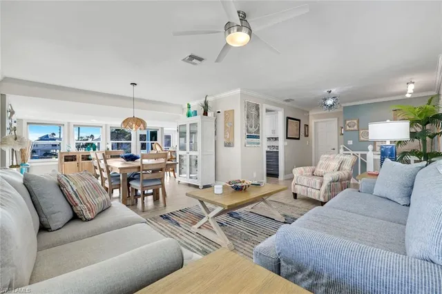 a living room with lots of furniture and kitchen view
